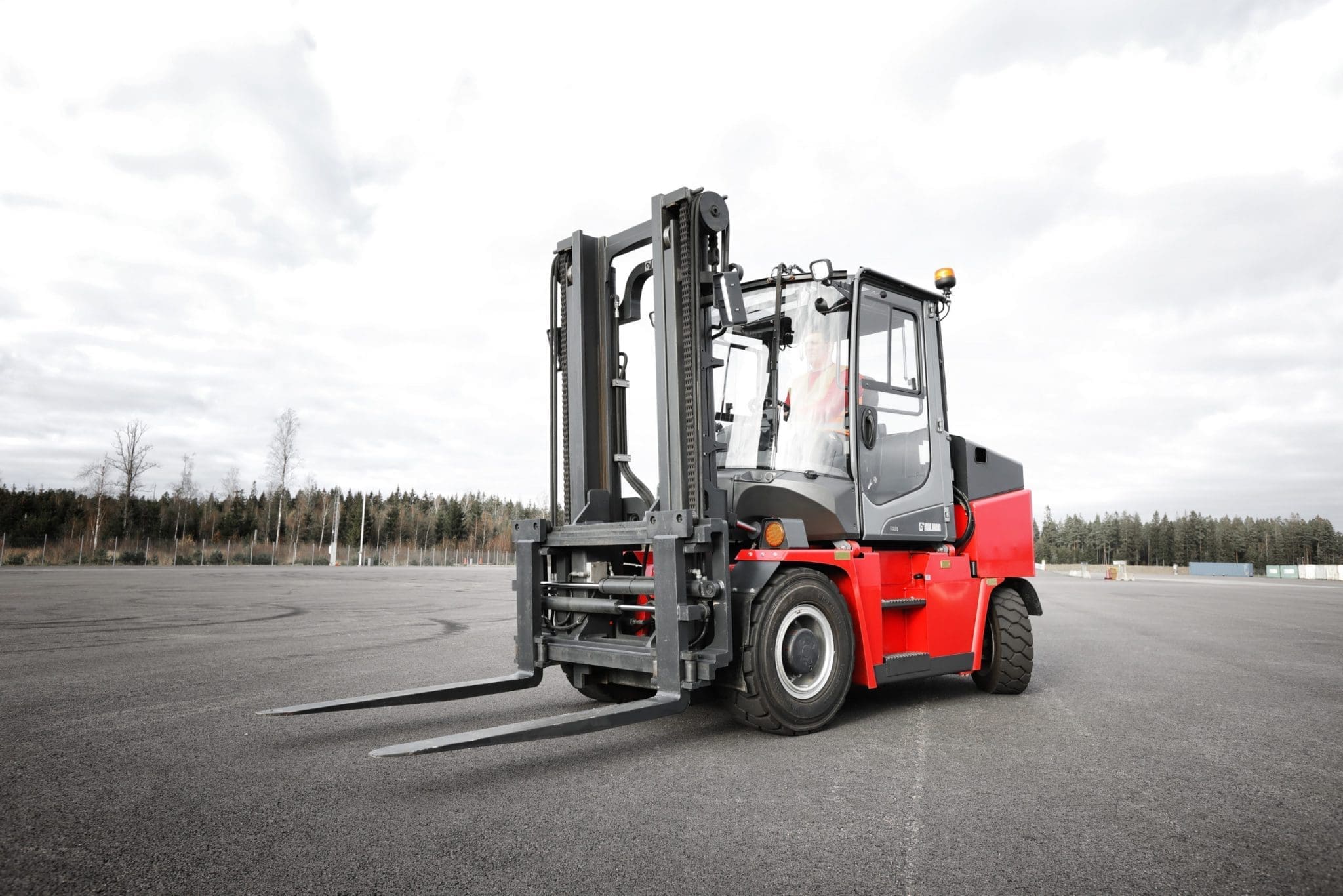 Forklift moving through a warehouse aisle